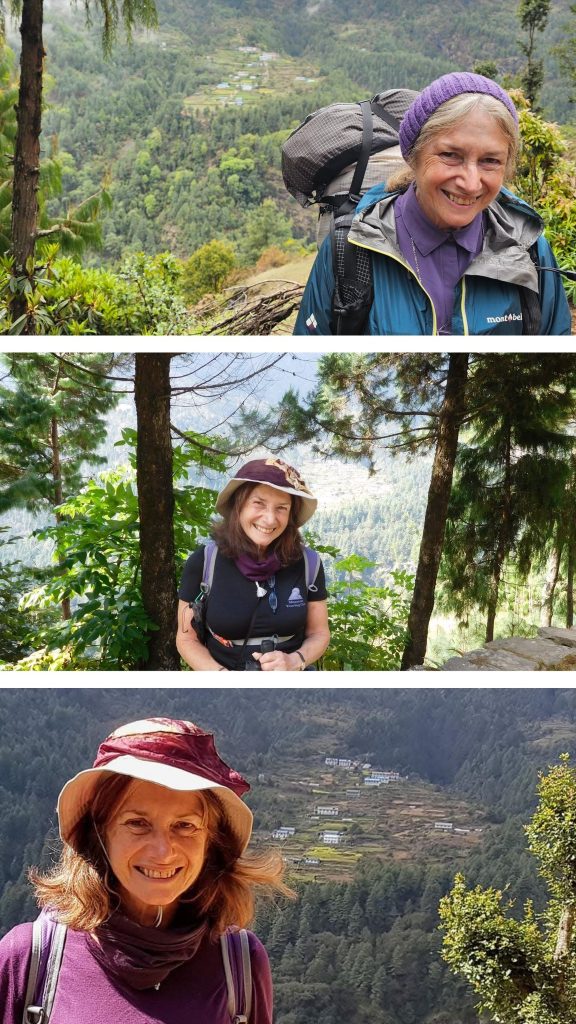 Smiling woman hiker with purple beanie and large backpack on a mountain overlook.
